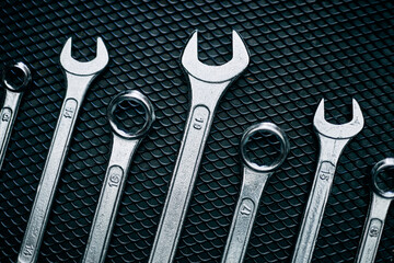 Set of chrome wrenches on steel surface. Mechanic tools for maintenance. Hardware tools to fix