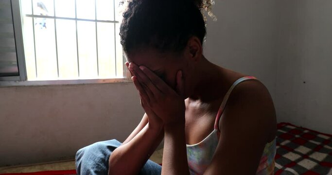 Boyfriend consoling depressed crying girlfriend in bed at home