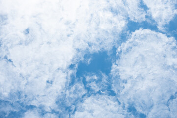 Blue sky and clouds that look like white paint on a blue background.