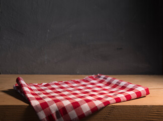 Empty wooden deck with table cloth, napkin over wall background