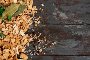 Frame from wood chips for smoking on a dark wood background top view. Copy space for text. Wood...