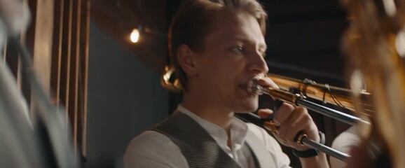 HANHDHELD CU Portrait of jazz band members playing brass instruments in recording studio during rehearsal. Shot on ARRI Alexa Mini with 2x anamorphic lens