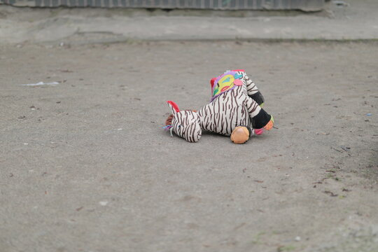 abandoned toy by children in the yard lies on the ground - Powered by Adobe