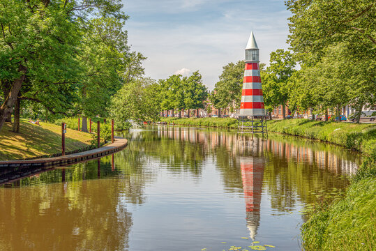 Cityscape of the Dutch city of Breda. The photo shows the Academiesingel and in the background the red and white lighthouse, installed in 1992, designed by the Italian architect Aldo Rossi.
