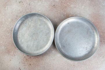 Old metal plates for scales on concrete background.