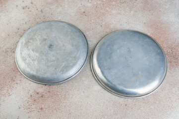 Old metal plates for scales on concrete background.