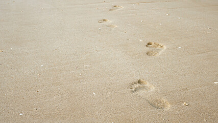 Footprints on the beach sand, Surface of human footmarks on smooth sand at the seaside, In summer, Texture background