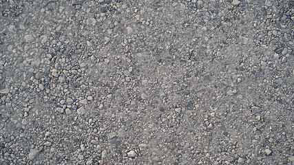 Granite gravel of macadam, Rock gray crushed for construction on the ground, Scree texture background © Jomic