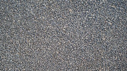 Granite gravel of macadam, Rock gray crushed for construction on the ground, Scree texture background