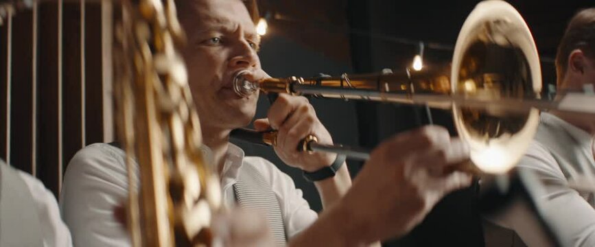 HANHDHELD CU Portrait of jazz band members playing brass instruments in recording studio during rehearsal. Shot on ARRI Alexa Mini with 2x anamorphic lens