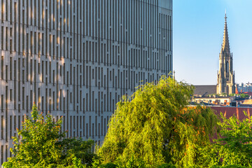 Katowice, Silesia, Poland; June 4, 2021: Close-up on the office building in modern business center against city scape - obrazy, fototapety, plakaty