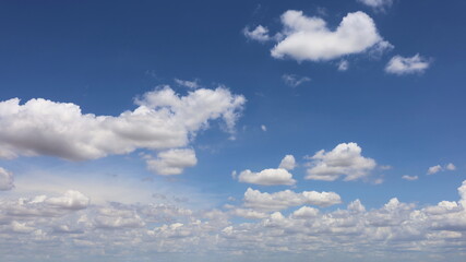 White clouds in the blue sky. Many beautiful fluffy clouds on the blue sky background during the rainy season. select focus