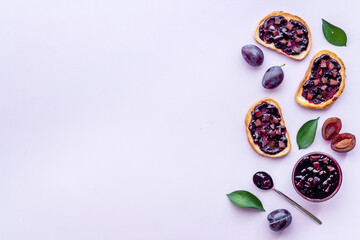 Toasted bread with plump jam. Food layout top view