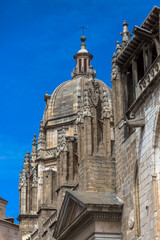 Fototapeta na wymiar Detailed view at the lateral facade ornaments and tower dome, gothic monument building Primate Cathedral of Saint Mary of Toledo