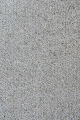 Texture from sheet of recycled light brown cardboard. Close-up vertical view of abstract recycled eco-friendly material pattern background.