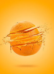 Orange fruit sliced with splashing juice on colored background