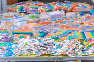 Fototapeta na wymiar Pop It silicone sensory anti-stress Fidget kid toy colorful rainbow game. Calming tools, adult stress reliever popping, trendy push bubble toys. 