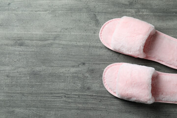 Pair of house slippers on gray textured background
