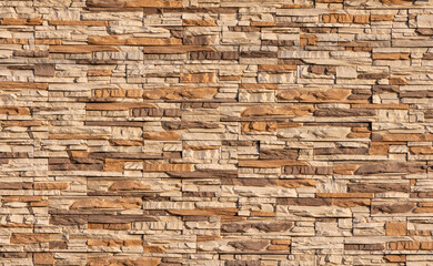 Texture wall stone sandstone with shadows and deep pattern. Clinker tiles or bricks on the wall in the form of wild stone