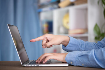 Fototapeta premium Man using laptop to work indoors