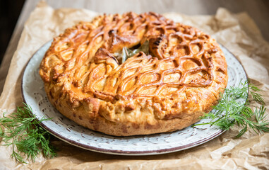 Puff pastry pie with chicken and leek decorated with dill. Close up. © valentinamaslova