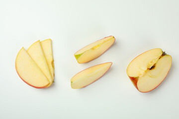 Ripe apple slices on white background, top view