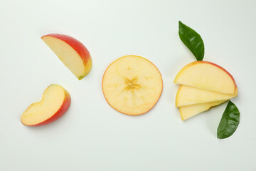 Ripe apple slices on white background, top view