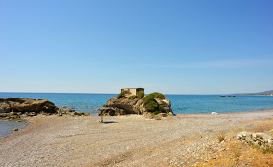 Obraz premium Beach with little hut on a rock in Kiotari Rhodes, Greece