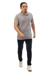 Fototapeta premium Asian man wearing grey shirt black denim and white shoes, walking forward, side view, happy confidence expression. Full body portrait isolated