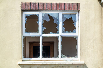 Broken glass after break and vandalism at window