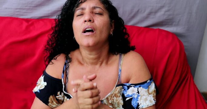 Evangelical Brazilian woman praying to God. Spiritual mature person praising God