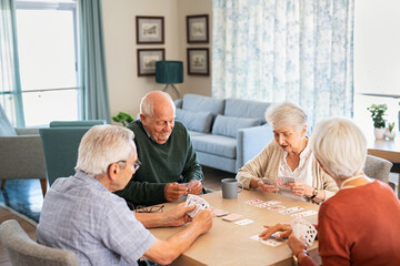 Senior friends playing cards together at nursing home - Powered by Adobe