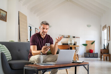 Business man doing video call at home with smartphone