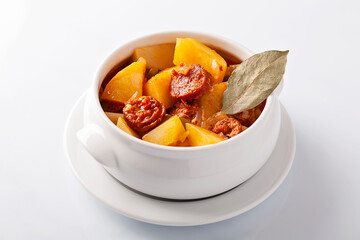 Patatas a la riojana, potatoes stew with chorizo on white background