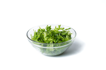 Fresh arugula in a plate. Vegan food concept. transparent plate with arugula. isolated on white.