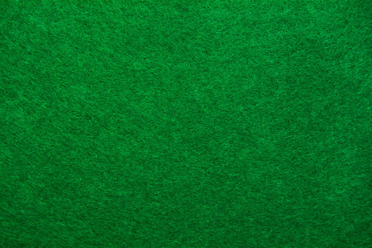 A close up of green felt material background. Textured fabric backdrop. Copy space