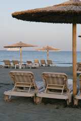 Empty sans beach with umbrellas, nobody because of virus, tourism crisis