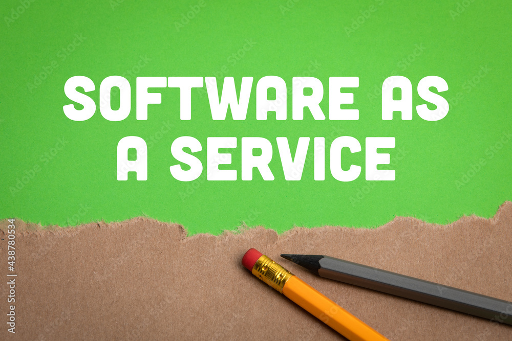 Wall mural software as a service. torn cardboard and pencils on a green background
