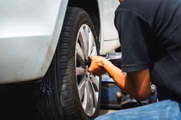 The technician doing assembling car wheel after finish repaired tire