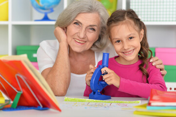 Girl doing homework with her grandmother at home