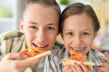 Porait of happy family eating pizza together