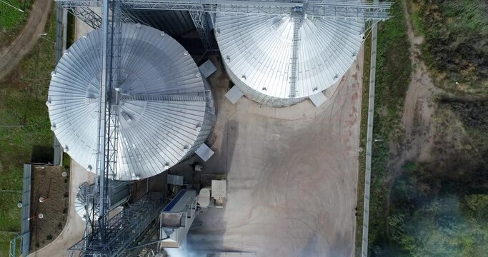 Steel big grain elevators. Industrial grain storage tanks. Arrial view.