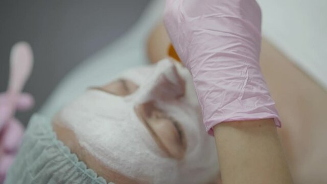 applying cosmetic mask to the patient's face. High quality 4k footage