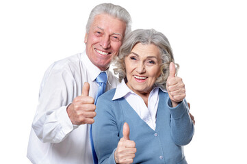 happy senior couple showing thumbs up