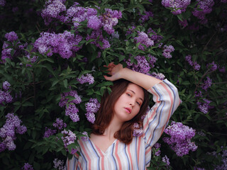 beautiful young asian woman enjoying the blooming of flowers in spring