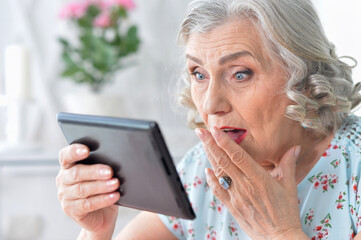 Portrait of  Old woman  with tablet pc