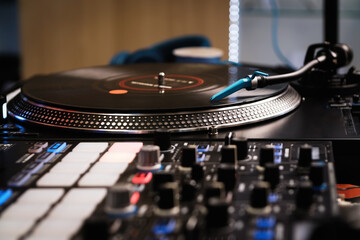 Professional dj setup. Analog turntable with vinyl record and sound mixer with push pads. High...