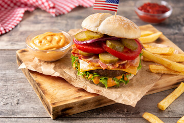 Beef burger with bacon on rustic wooden table