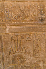 Egyptian hieroglyphs and engravings on the walls of Kom Ombo Temple on the Nile river in Egypt including Cleopatra giving birth