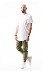 Fototapeta premium Shaved bald bearded young man in casual stylish clothes looking at camera. Full body length isolated on white background